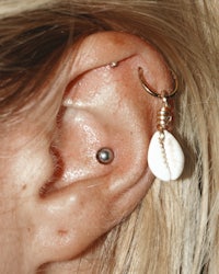 a woman's ear with a shell ear piercing